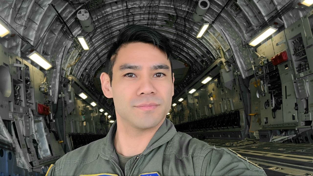 George Embry in flight suit, standing in the cargo bay of a C-17